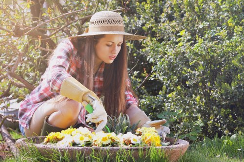 Kneeling gardener checking plants as part of compliance monitoring